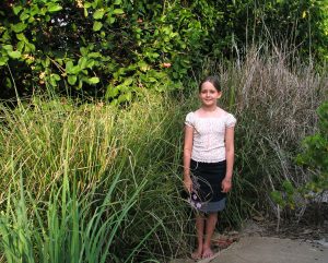Aleisha standing with Vetiver Grass